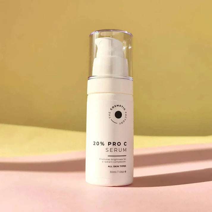 a bottle of 20% pro c serum 30ml on a yellow surface.