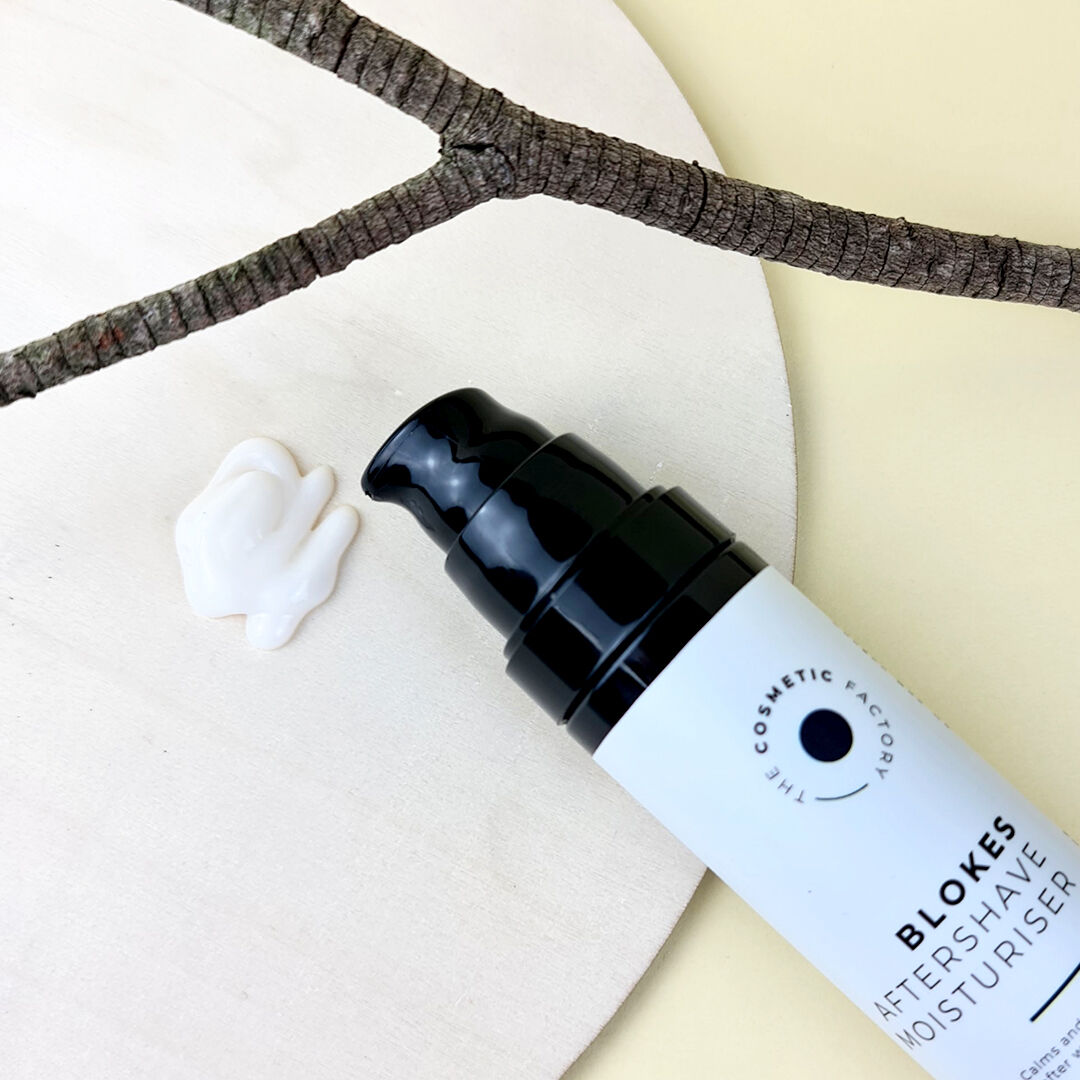 a bottle of blokes aftershave moisturiser 50ml next to a branch.