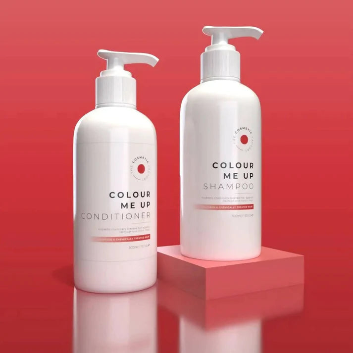 two bottles of colour me up shampoo 300ml on a coloured surface.