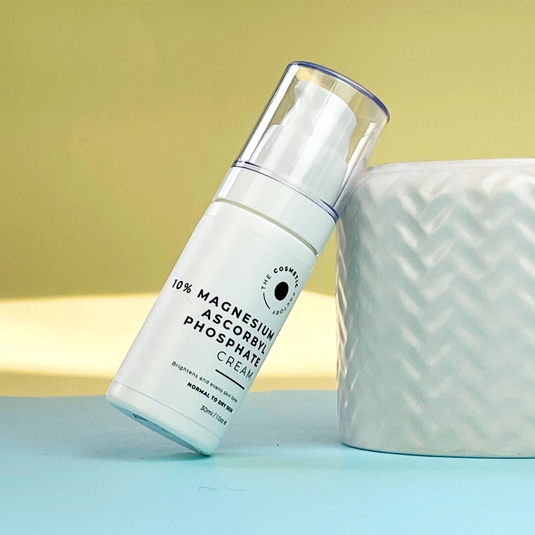 a bottle of 10% magnesium ascorbyl phosphate cream 30ml leaning on a white container.